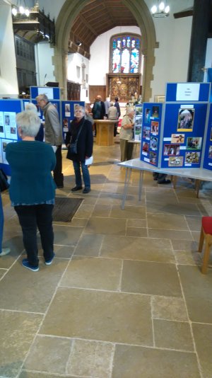 Visitors to the exhibition study the display material