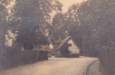 B&W photograph of former thatched cottage at the junction of Church Road and Whites Lane, opposite the Church of St James the Great